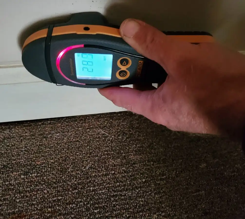Moisture detection at baseboard during Storm Damage Restoration in Slaton